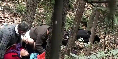 Two Asian MILFs and two guys are fucking in the woods