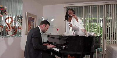 The ebony woman listens to the piano before getting banged