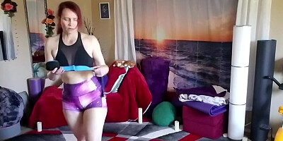 Redhead MILF is filmed while doing some stretching Yoga exercises